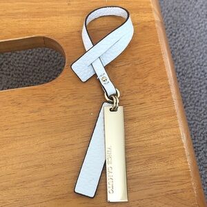 Vince Camuto Gold and White Leather bag charm. NEW
